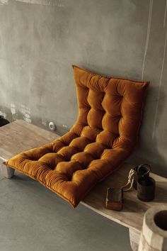 an orange chair sitting on top of a wooden table