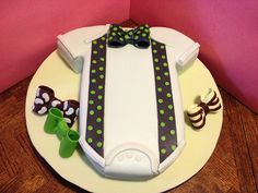 a cake decorated with green and white polka dots, bow ties and candy canes