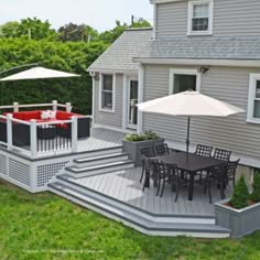 a deck with chairs and an umbrella on it