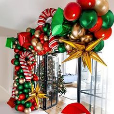 christmas decorations are on display in front of a glass door