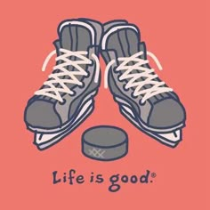 a pair of tennis shoes with the words life is good on it and an ice hockey puck