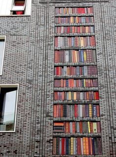 a tall brick building filled with lots of books