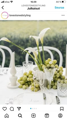 an image of a table setting with grapes and flowers