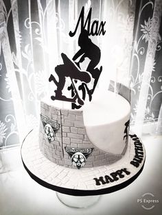 a cake with a skateboarder on it and the words max written in black