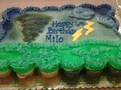 a birthday cake with green frosting and blue icing