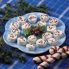 a blue plate topped with lots of food on top of a table next to candy canes