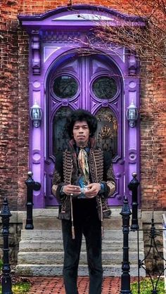 a man standing in front of a purple door