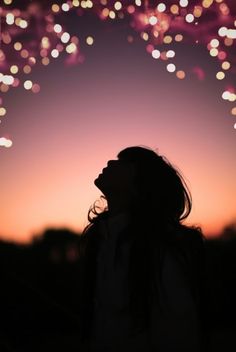 a woman looking up at fireworks in the sky with a quote on it that says,