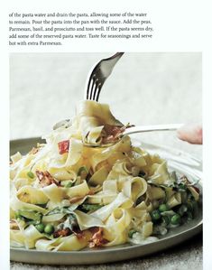 a plate full of pasta and peas with a fork in it