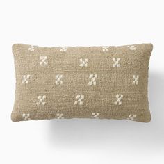 a beige pillow with white crosses on it