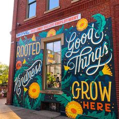 a painted mural on the side of a building that says, good things grow here