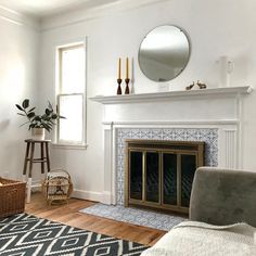 a living room filled with furniture and a fire place next to a mirror on the wall