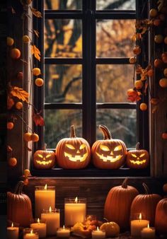 halloween pumpkins and candles in front of a window