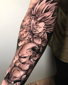 a man's arm with a dragon and flowers tattoo on the left forearm, in black and grey ink