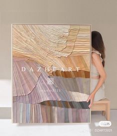 a woman standing in front of a painting with the words dazzle heart on it