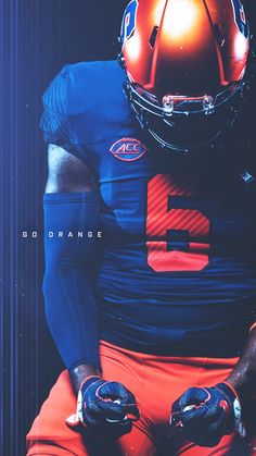 an orange and blue football uniform with the number two on it's chest, sits in front of a black background