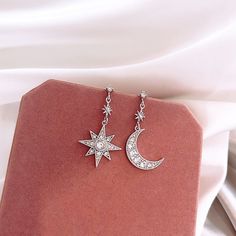 You can be the star of the show with these sparkly celestial stars and moon earrings! The asymmetry is very on-trend right now and will have all your friends asking about them!. Wear these on your next special occasion! DETAILS & SIZE Finish: Gold or silver plate Material: Alloy; CZ crystals Measurements: Moon and star pendants: 18mm length Comes with friction earring backs Shop the Celestial collection for more options! Or shop Earrings for more options! Moon Earrings Silver, Celestial Crystal, Silver Star Earrings, Celestial Earrings, Moon And Star Earrings, Star And Moon, Crystal Fashion, Mismatched Earrings, Crystal Stars