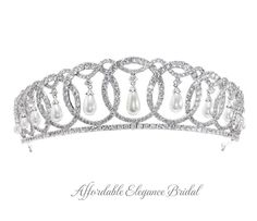 Grand Duchess Vladimir Royal Replica Tiara Crown This regal tiara is a replica of the tiara created for Grand Duchess Maria Pavlovna of Russia as pictured on Queen Elizabeth. This fabulous 2" tall silver platinum plated headpiece features a unique design of interlocking circles accented with hanging pearls. The AAA quality cz crystals and luminous shell pearls will provide sparkle from every angle! This crown will ensure head-turning elegance on your big day. Color: Silver. Style: hp223QE. Size: About 2 " tall at the center peak. An unforgettable crown for your wedding day! Please allow 2-3 weeks for delivery. Shipping Policy . Return Policy. Vladimir Tiara, Grand Duchess Vladimir, Winter Wedding Accessories, Maria Pavlovna, Gold Bridesmaid Jewelry, Beaded Wedding Veils, Rose Gold Tiara, Rose Gold Wedding Jewelry, Flower Girl Jewelry