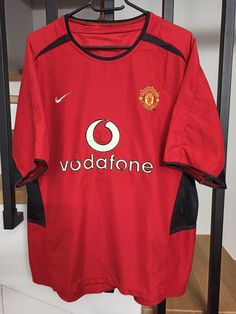 the manchester united shirt is hanging on a rack