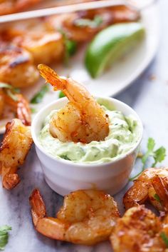 shrimp and guacamole dip with cilantro garnish on the side