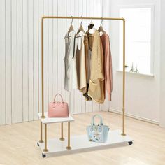 a rack with clothes and purses hanging on it