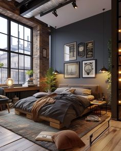 an industrial style bedroom with brick walls and wooden floors, along with large windows that let in natural light