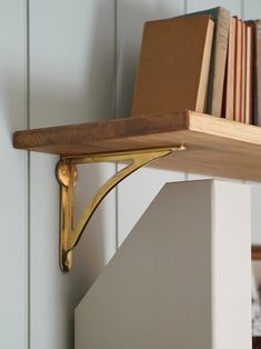 a bookshelf with some books on top of it and a book case in the background