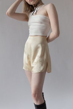 "Bridal silk tap shorts for \"Chippy\" from Bergdorf Goodman in the 1920s. Complete with custom embroidery and tiny mother of pearl buttons at side. The softest cream silk. Very wearable for today and in excellent shape. BRAND / Bergdorf Goodman MATERIAL / 100% Silk CONDITION / Some minor discolorations on back but overall in excellent shape for their age. SIZE / US 0 MEASUREMENTS / Waist - 24\" / Hip - 36\" Nicolette is a size 24 and 5'3" Elegant Fitted Cream Shorts, Silk Bottoms For Summer Daywear, Summer Silk Bottoms For Daywear, Fitted Silk Bottoms Short Length, Chic Silk Shorts, Cream Silk Bottoms For Spring, Spring Silk Cream Bottoms, Spring Cream Silk Bottoms, Elegant Short Silk Bottoms