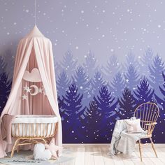 a baby's room decorated in pink and blue with trees painted on the wall