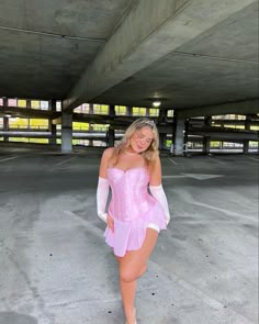 a woman in a pink corset posing for the camera