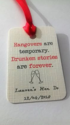 a white tag with a red string attached to it that says hangover are temporary, drunken stories are forever