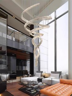 a living room filled with furniture and a spiral chandelier