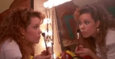 two women looking at themselves in the mirror