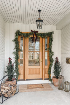 Front door views, holiday home, seasonal finds, front door refresh, faux garland, faux tree, velvet ribbon, neutral home, aesthetic home, doormat finds, Christmas entry, Amazon, Target, William-Sonoma, holiday finds, creamy whites, warm woods, neutral Christmas vibes, warm and cozy, Target Christmas style, Amazon Christmas, holiday front entry look, lighting detail, red velvet detail, light and bright, neutral front entry, cozy winter vibes White House With Christmas Wreaths, Christmas Porch Double Doors, White House Christmas Decorations Exterior, Garage Door Wreath, Exterior Wreaths Christmas, Christmas Wreaths For Double Front Door, Christmas Lights On House Exterior Farmhouse, Christmas Double Door Decor, Wreaths Outside Windows