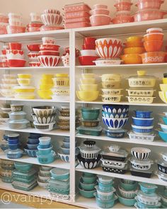 the shelves are filled with colorful bowls and plates