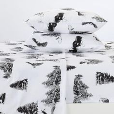 three pillows are stacked on top of each other with black and white images all over them