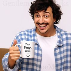 a man is holding a coffee mug and giving the thumbs up sign with his right hand