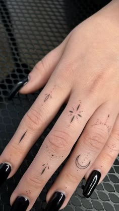 a woman's hand with tattoos on it