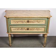 an antique chest of drawers with marble top