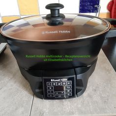 a black and brown crock pot sitting on top of a counter