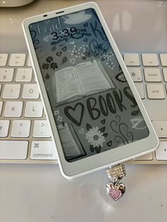 an electronic device sitting on top of a keyboard