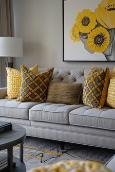 a living room filled with furniture and yellow flowers on the wall above it's couch