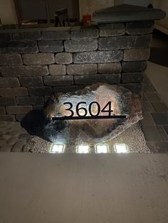 a brick fireplace with the number 3604 carved into it's side and surrounded by bricks