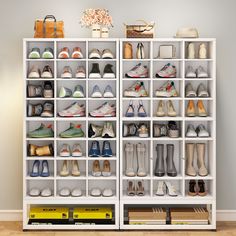 a white shelf filled with lots of shoes