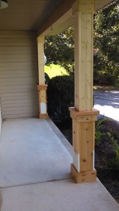 an outside view of a porch with wooden posts