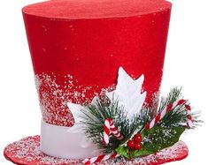 a red and white top hat decorated with candy canes, holly and snowflakes