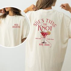 a woman wearing a t - shirt that says she's tying the knot