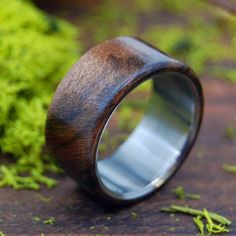 a wooden ring sitting on top of green moss