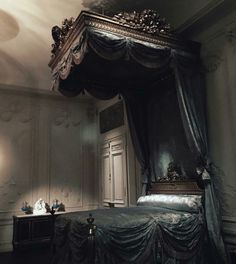 a canopy bed in the corner of a room