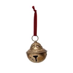 a bell ornament with a red ribbon hanging from it's side on a white background